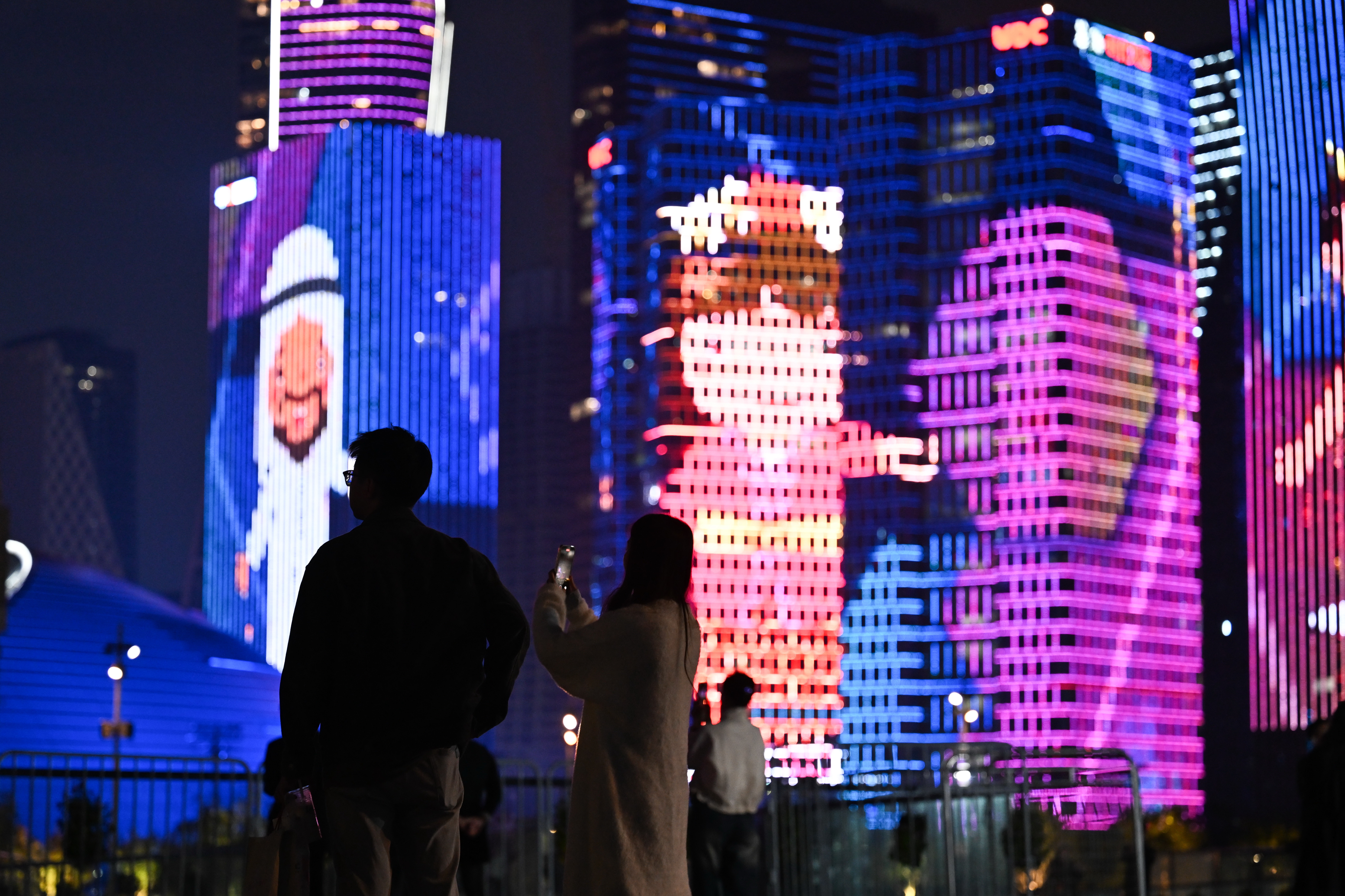 Visitors take photos to capture a beautiful light show during the opening of the 4th Asian Paralympic Games in Hangzhou City, Zhejiang Province, October 22, 2023. /CFP