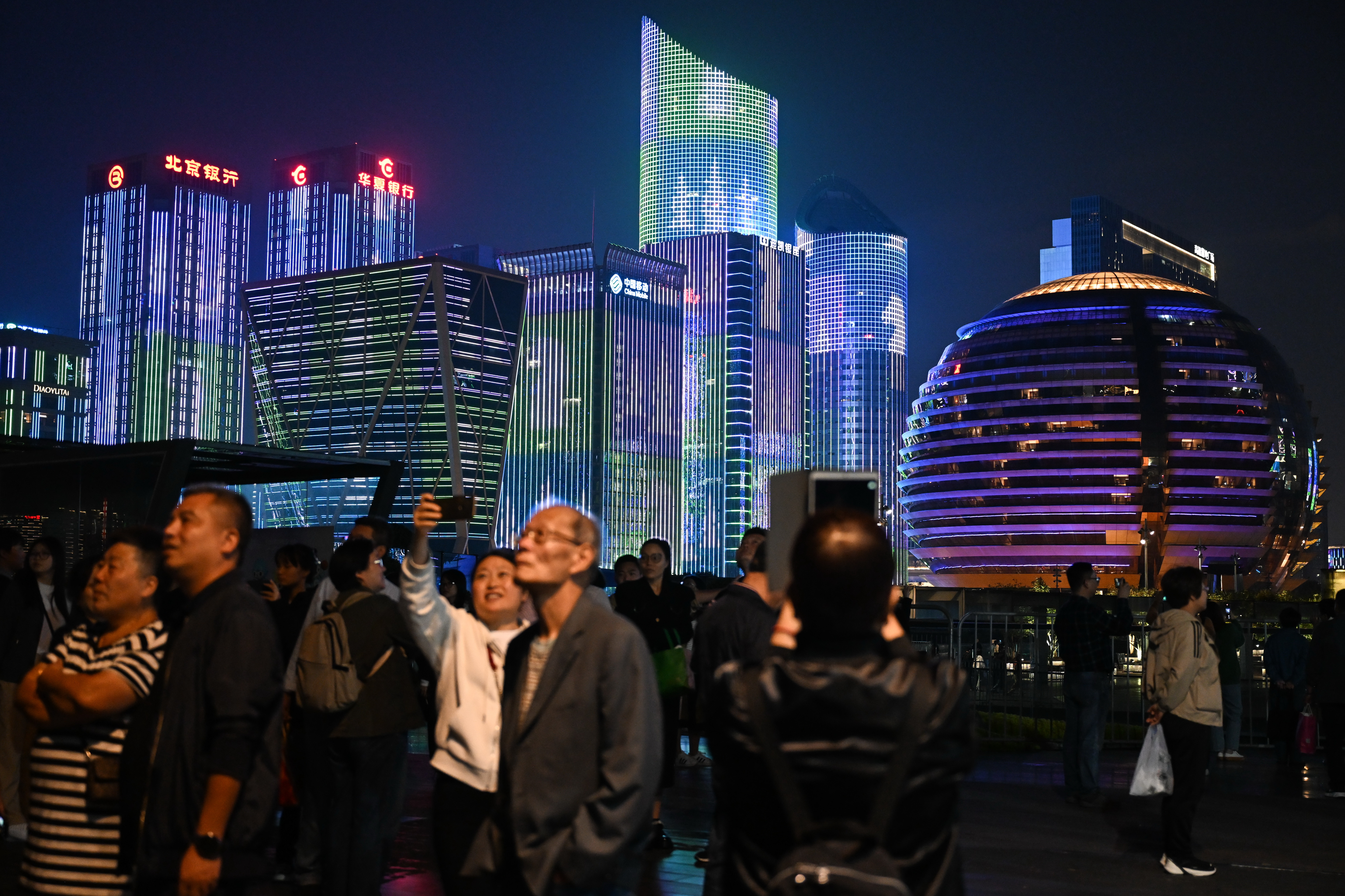 People enjoy a light show on the streets during the 4th Asian Paralympic Games in Hangzhou City, Zhejiang Province, October 22, 2023. /CFP