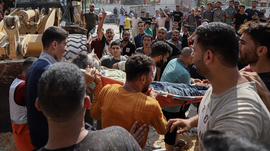 People carry a man rescued from collapsed buildings after Israeli air strikes in the southern Gaza Strip city of Khan Younis, October 24, 2023. /Xinhua
