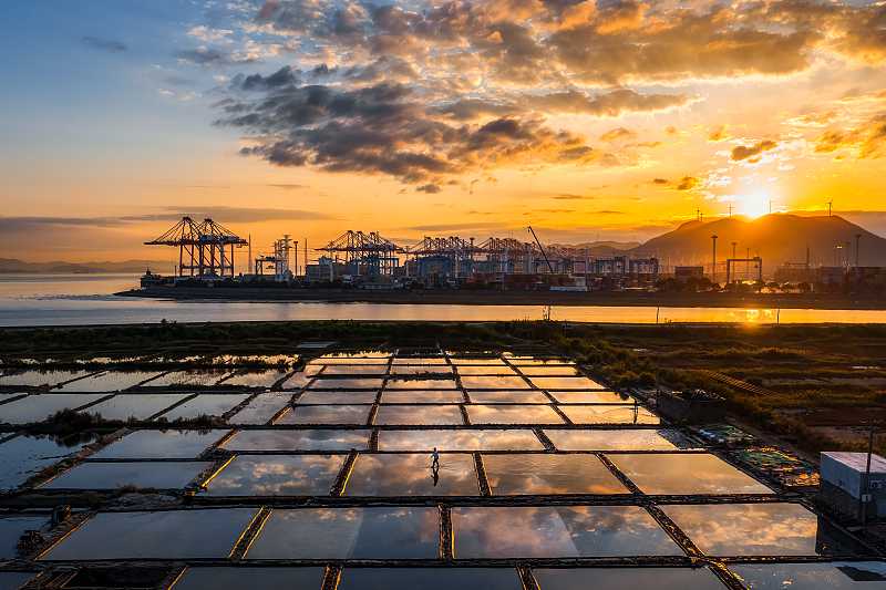 A photo captures a beautiful sunset over a salt farm in Ningbo, Zhejiang Province, October 24, 2023. /CFP