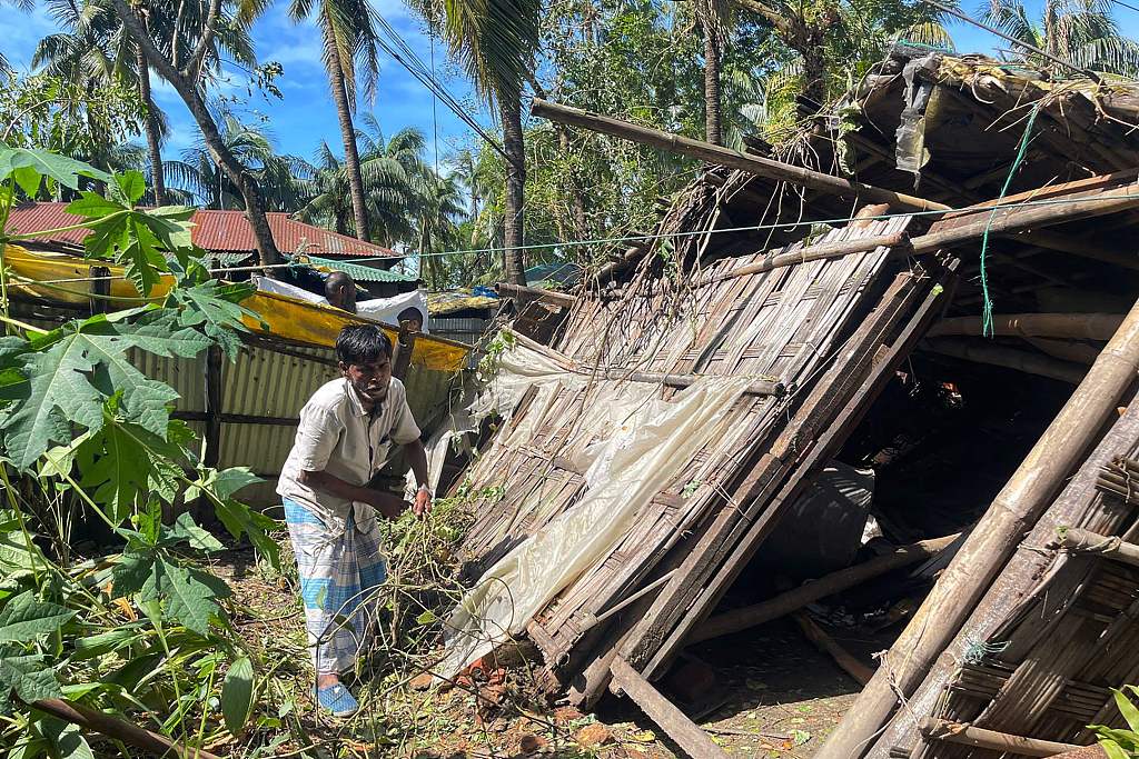 A man inspects his damaged home in Cox's Bazar following the landfall of Cyclone Hamoon. Cox's Bazar, Bangladesh.  October 25, 2023. /CFP