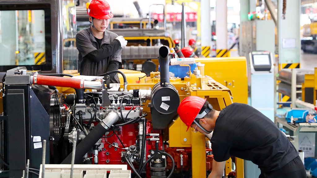 Workers operate on an excavator assembly line in east China’s Shandong Province, June 14, 2023. /CFP