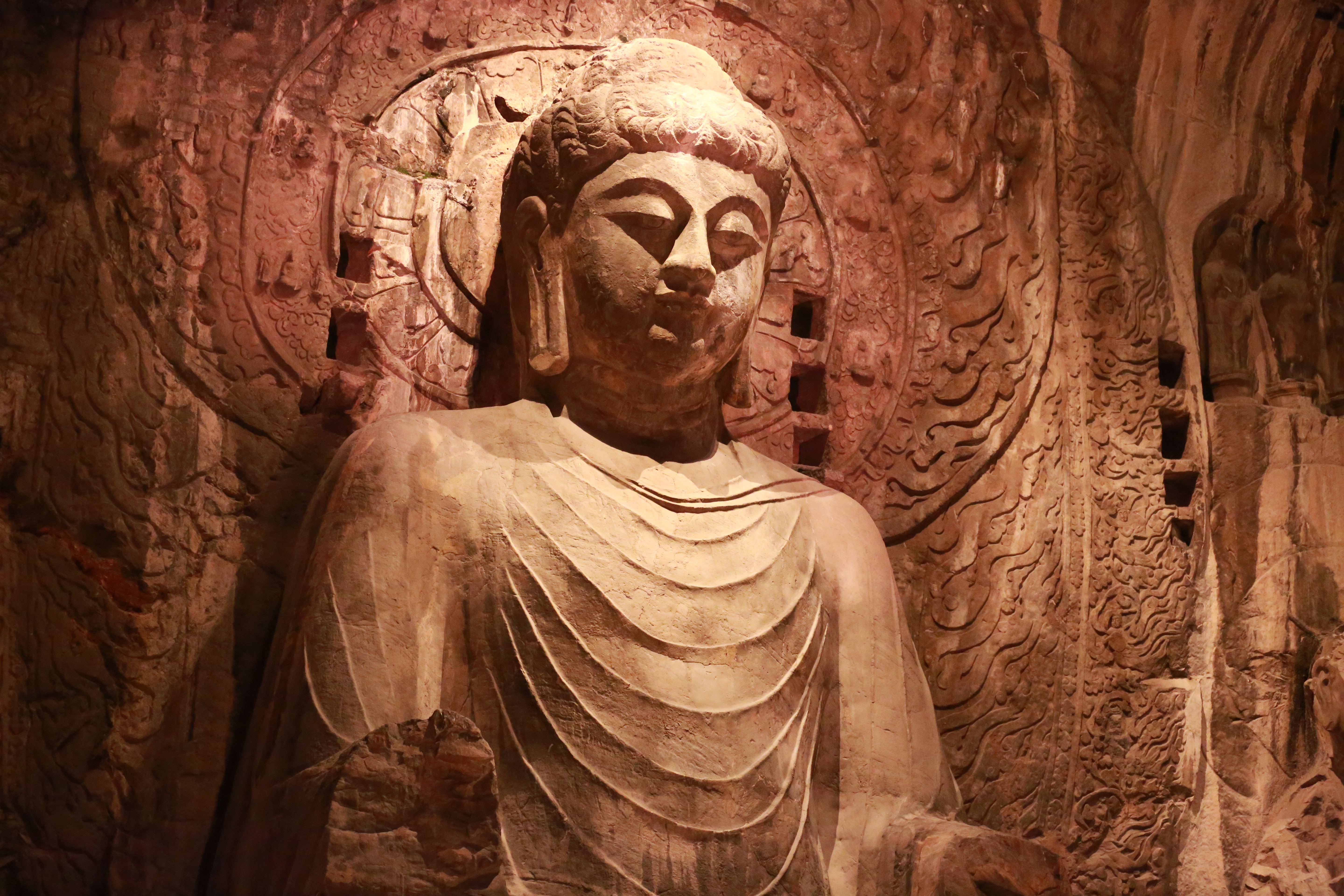 A Buddha statue of Longmen Grottoes in Luoyang, central China's Henan Province, is illuminated at night in this photo taken on October 26, 2023. /IC 