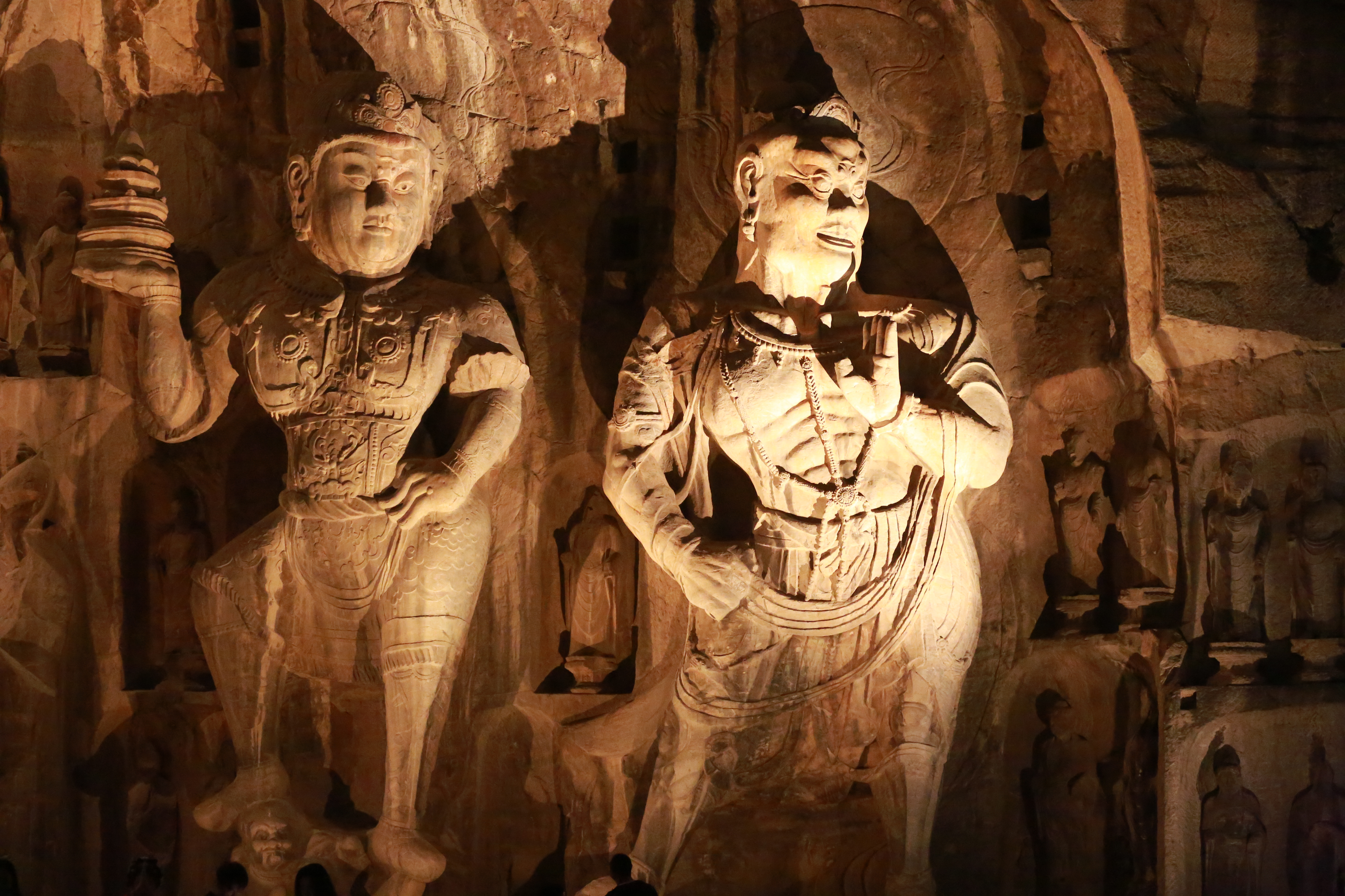 Buddha statues of Longmen Grottoes in Luoyang, central China's Henan Province, are illuminated at night in this photo taken on October 26, 2023. /IC 