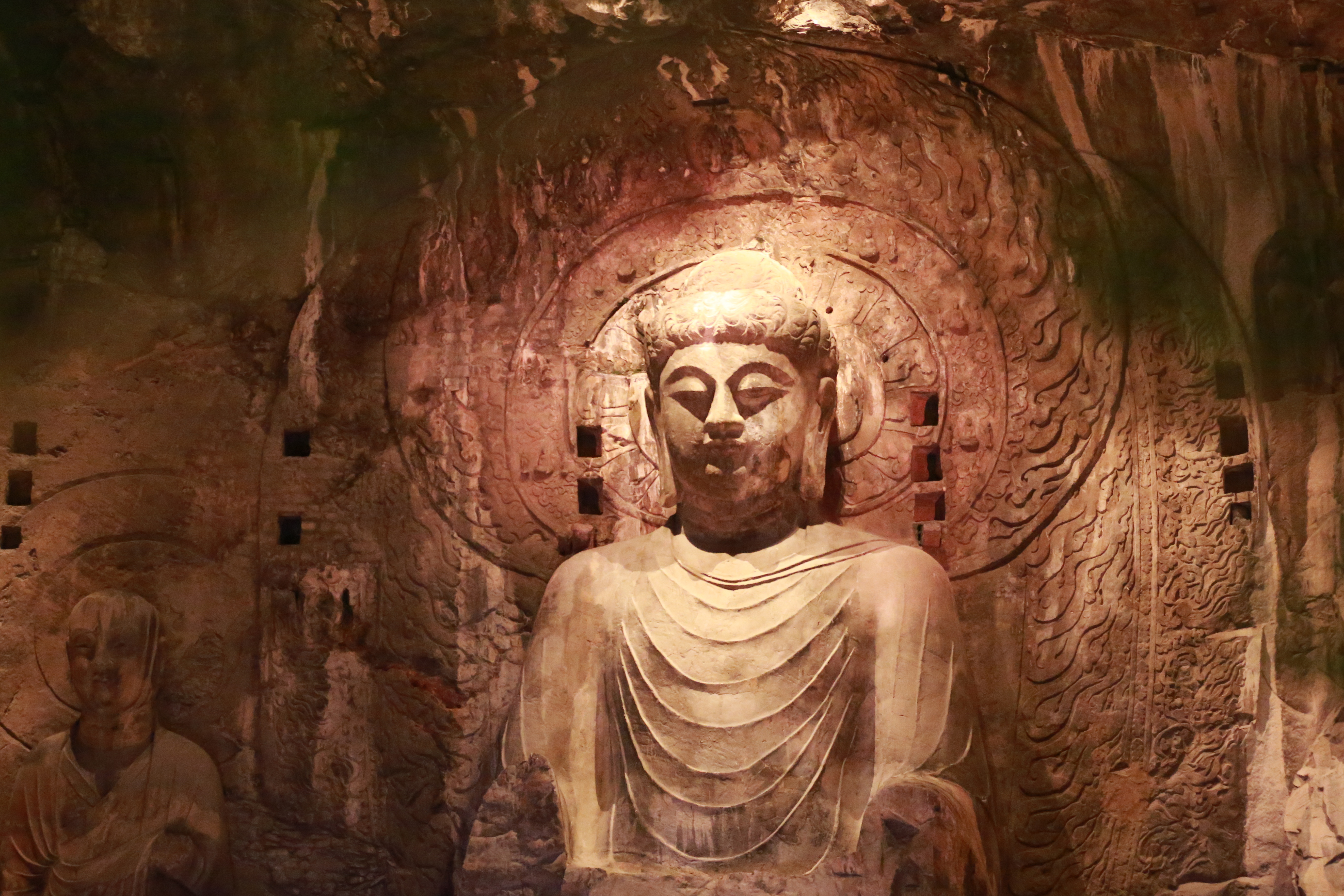 A Buddha statue of Longmen Grottoes in Luoyang, central China's Henan Province, is illuminated at night in this photo taken on October 26, 2023. /IC 