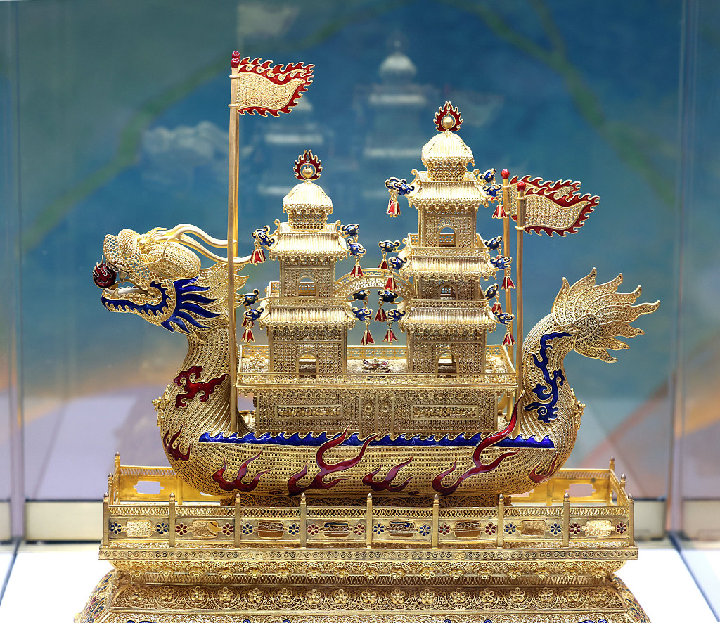 A gold dragon boat adorned with gemstones at the 2023 China International Jewelry Fair in Beijing is seen in this photo taken on October 26, 2023. /CFP