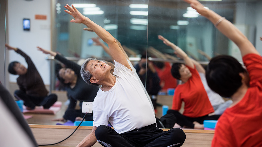 Elderly students take yoga classes at a university for the aged in Hangzhou City, east China's Zhejiang Province, October 31, 2022. /CFP
