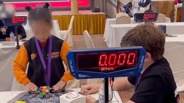 Cao Qixian (L) of China solves the 3x3x3 Rubik's Cube at the World Cube Association Rubik's Cube International Open in Singapore, September, 2023. /CMG