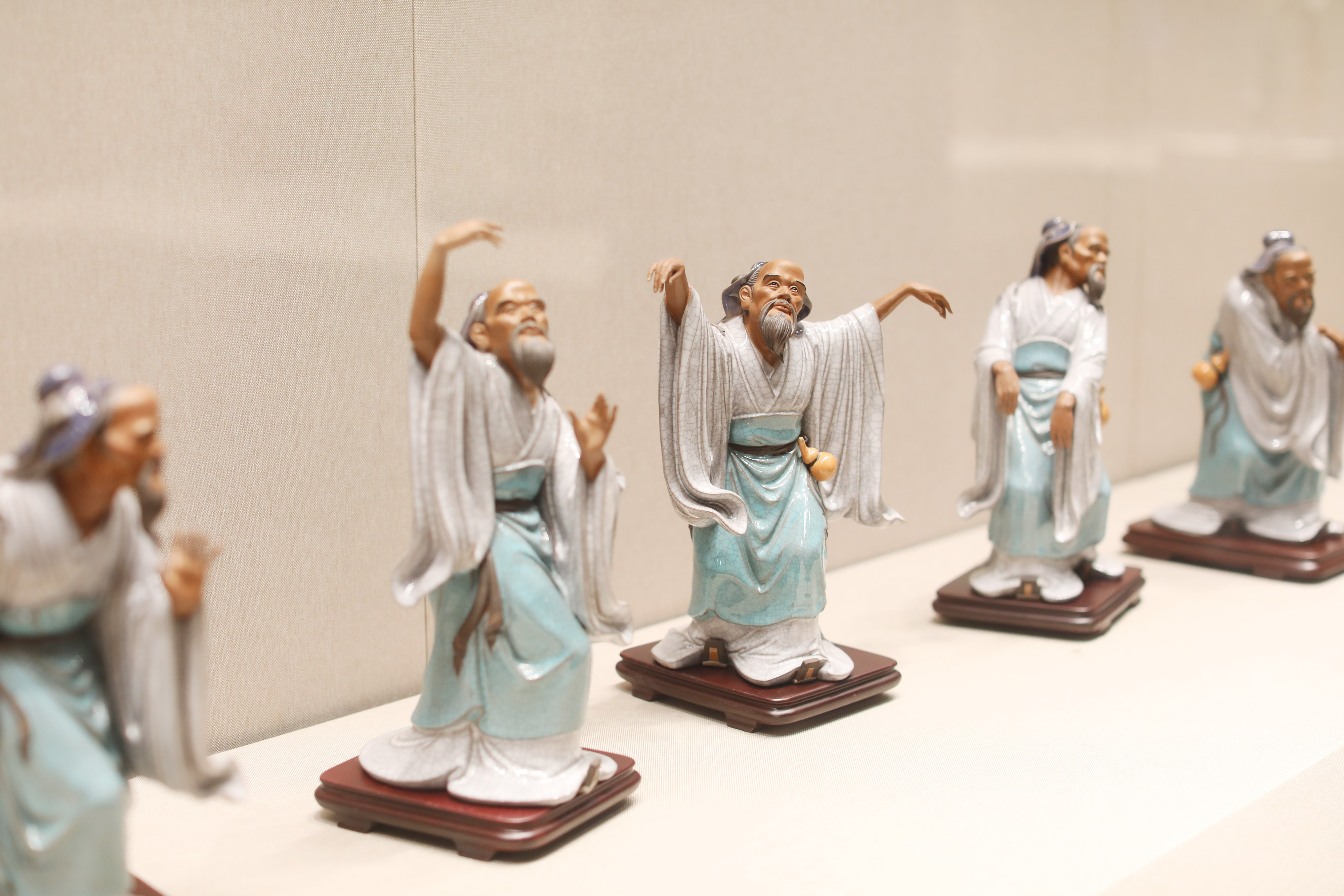 The photo taken on October 18, 2023, shows that some intricate ceramic figurines are on display at an exhibition in Foshan City, Guangdong Province. /IC 