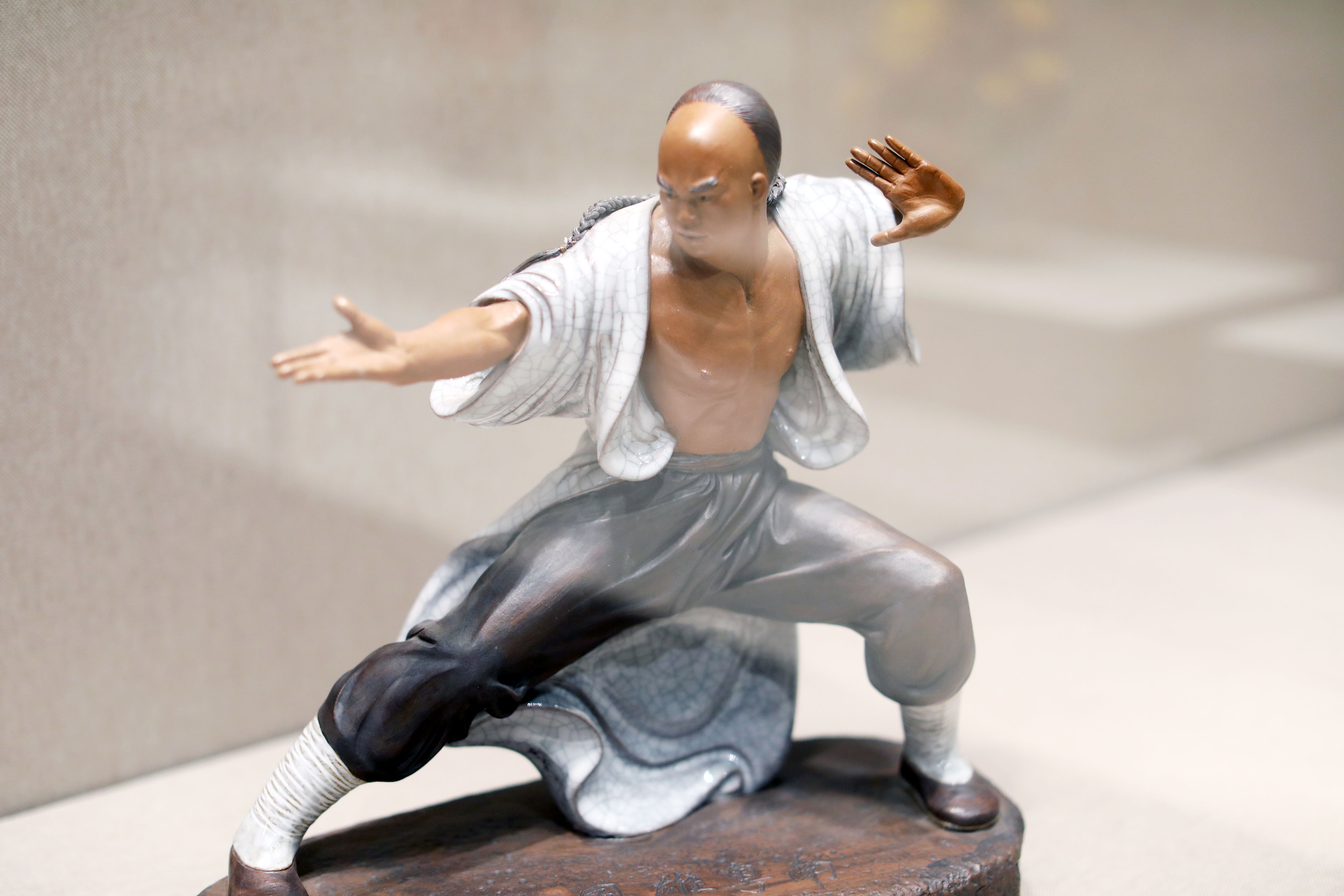 The photo taken on October 18, 2023, shows that a figurine of a man making a kung fu pose is displayed at an exhibition in Foshan City, Guangdong Province. /IC 