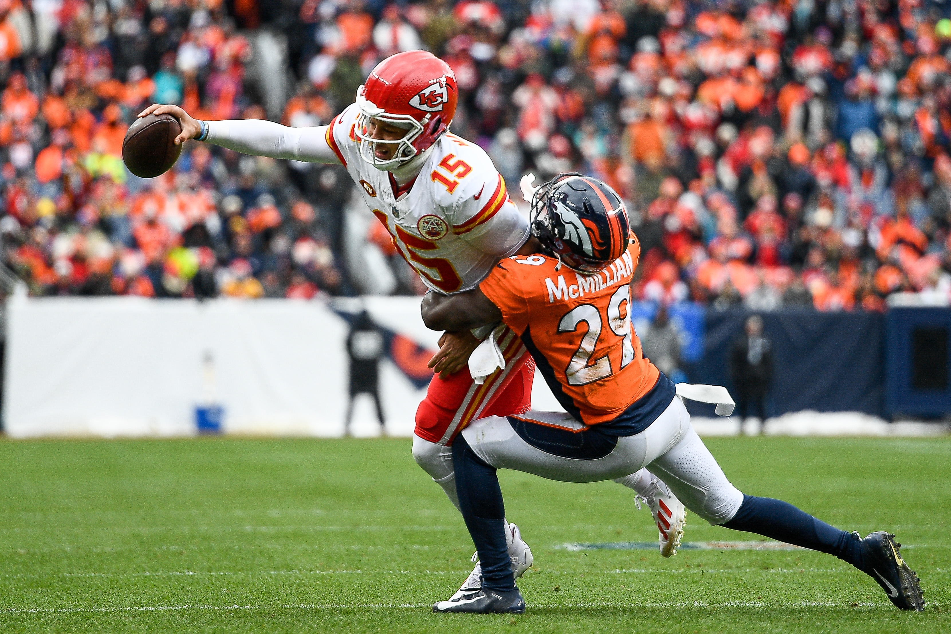 Quarterback Patrick Mahomes (L) of the Kansas City Chiefs is tackled by cornerback Ja'Quan McMillian of the Denver Broncos in the game at Empower Field at Mile High in Denver, Colorado, October 29, 2023. /CFP