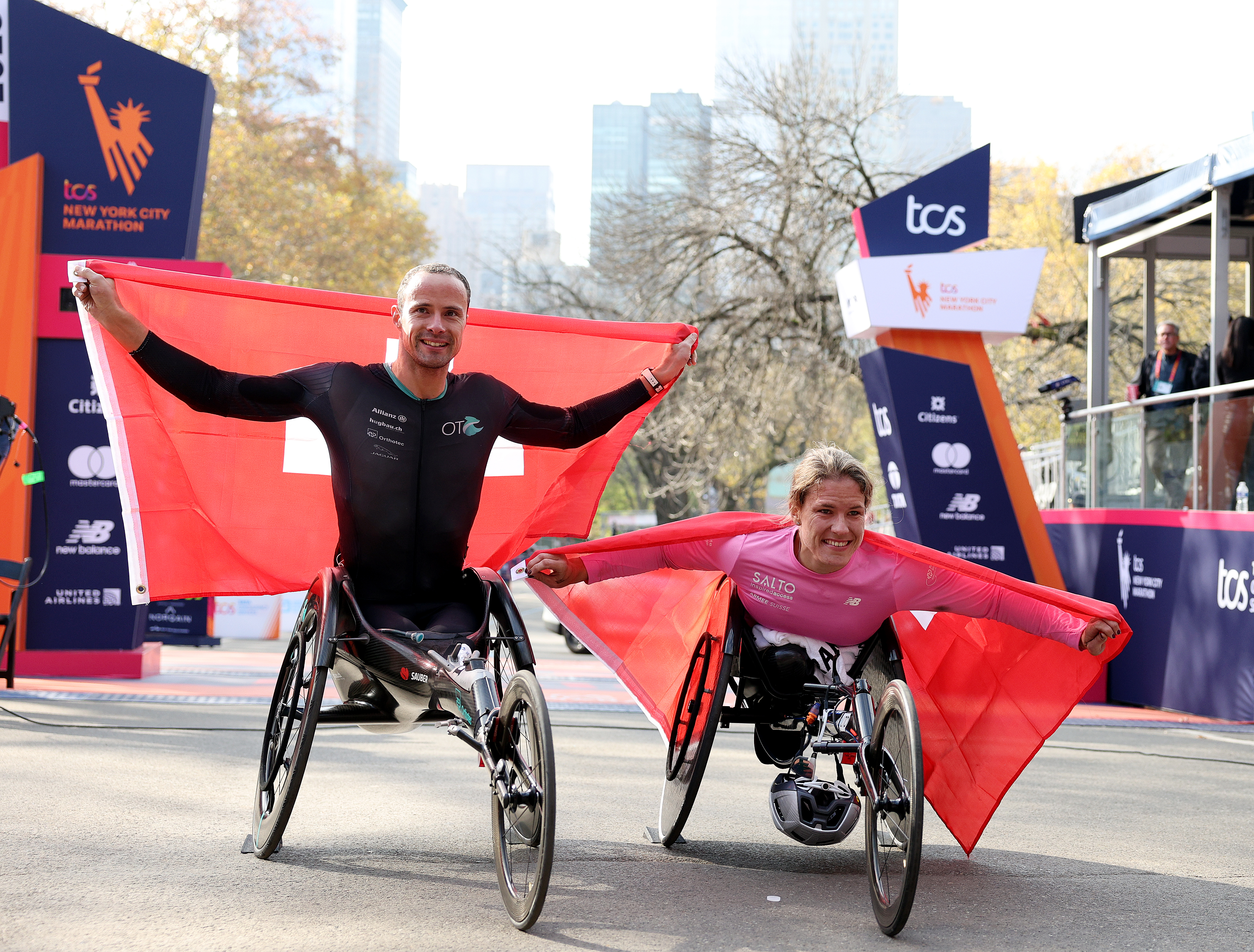Marcel Hug (L) and Catherine Debrunner of Switzerland celebrate after winning the New York City Marathon men's and women's wheelchair races, respectively, in New York City, November 5, 2023. /CFP