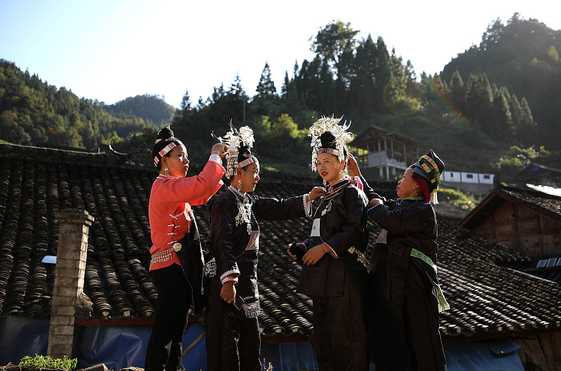 Miao women dressed in traditional costumes and silver accessories prepare to celebrate the Chixin Festival in Danzhai County, Qiandongnan Miao and Dong Autonomous Prefecture, Guizhou Province, November 6, 2023. /CFP