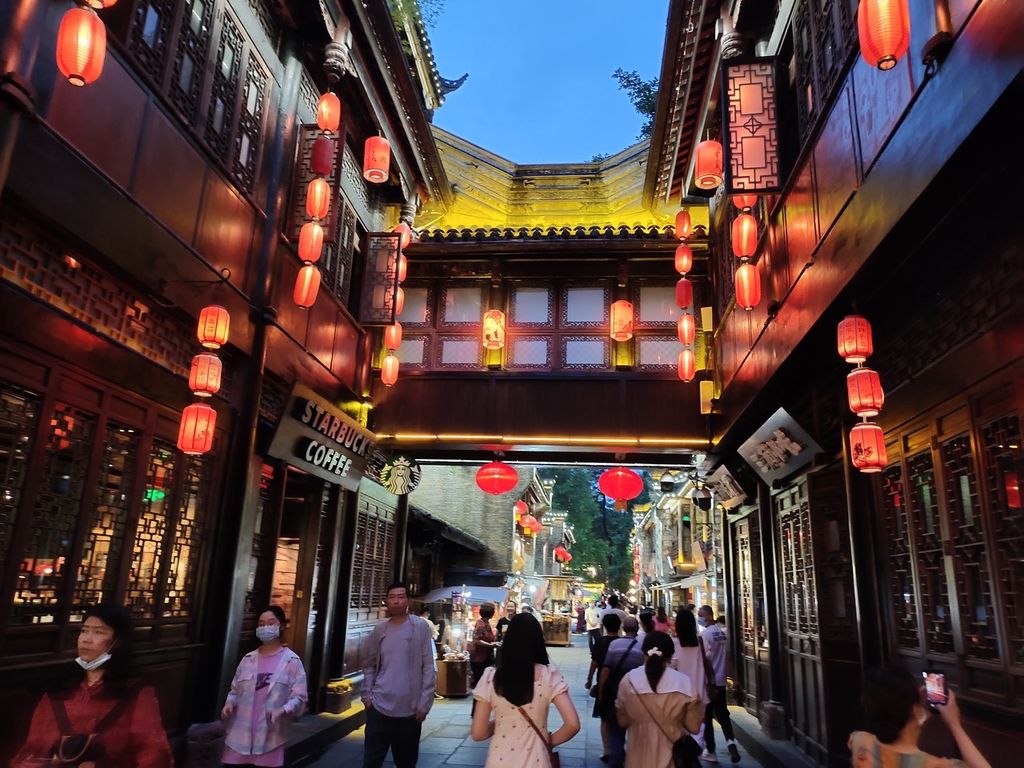 A photo taken on July 6, 2022 shows visitors strolling along Jinli Street, a preserved pedestrian zone in Chengdu, Sichuan ranked by CNN Travel as one of the most beautiful streets in the world. /IC