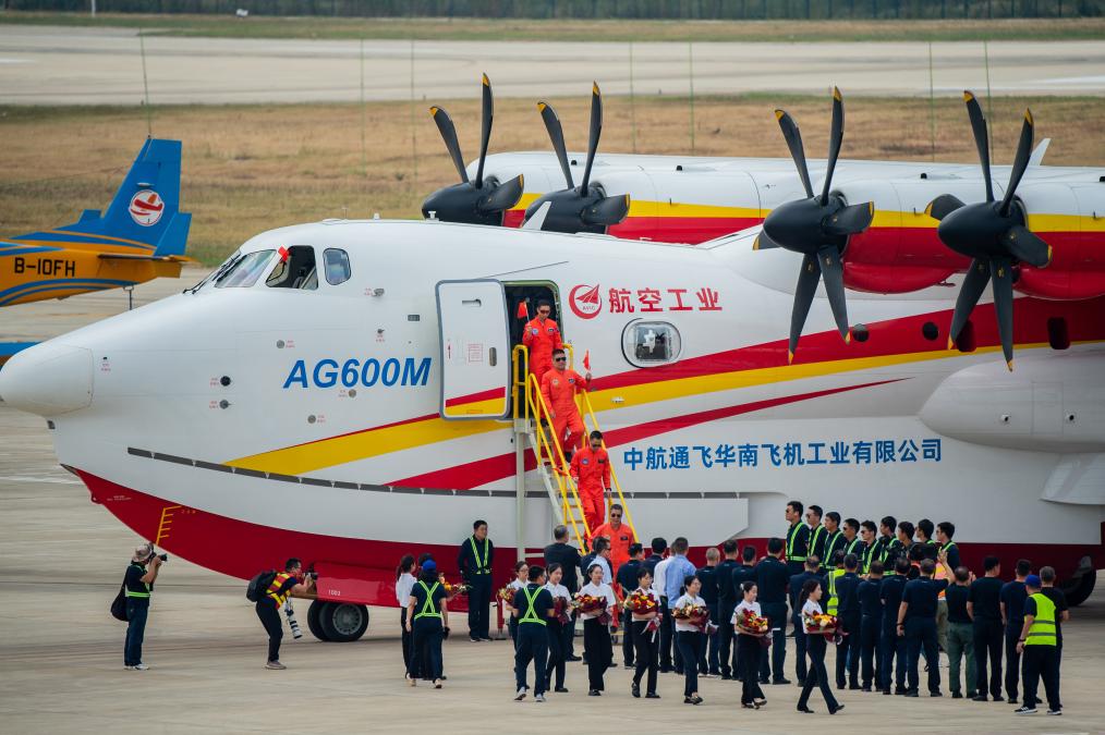 Crew members of an AG600M firefighting aircraft disembark from the plane after a water gathering and dropping test in Jingmen, central China's Hubei Province, September 27, 2022. /Xinhua