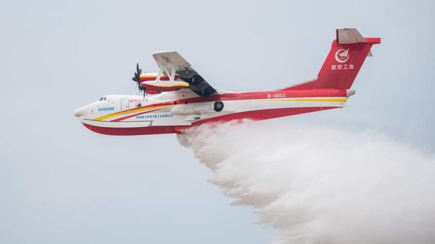 An AG600M firefighting aircraft drops water during a gathering and dropping water test in Jingmen, central China's Hubei Province, September 27, 2022. /Xinhua