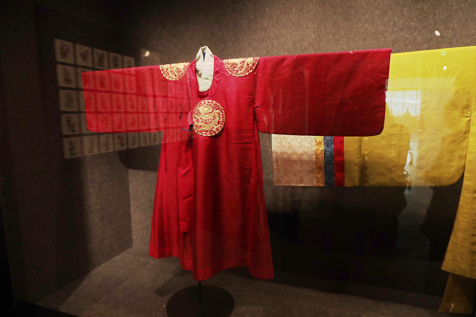 A red ground-gold embroidered robe from Korea is on display at the 