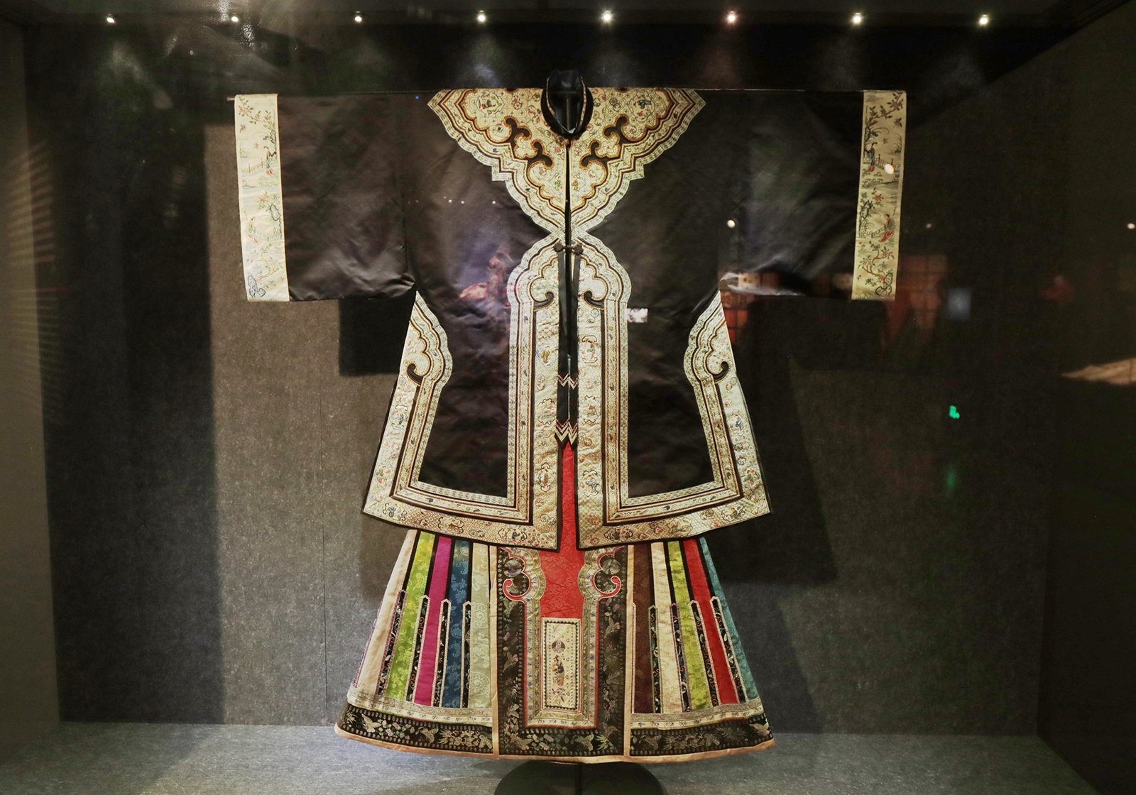 An embroidered woman's silk top and a pleated skirt embroidered featuring floral and butterfly motifs from China are on display at the 
