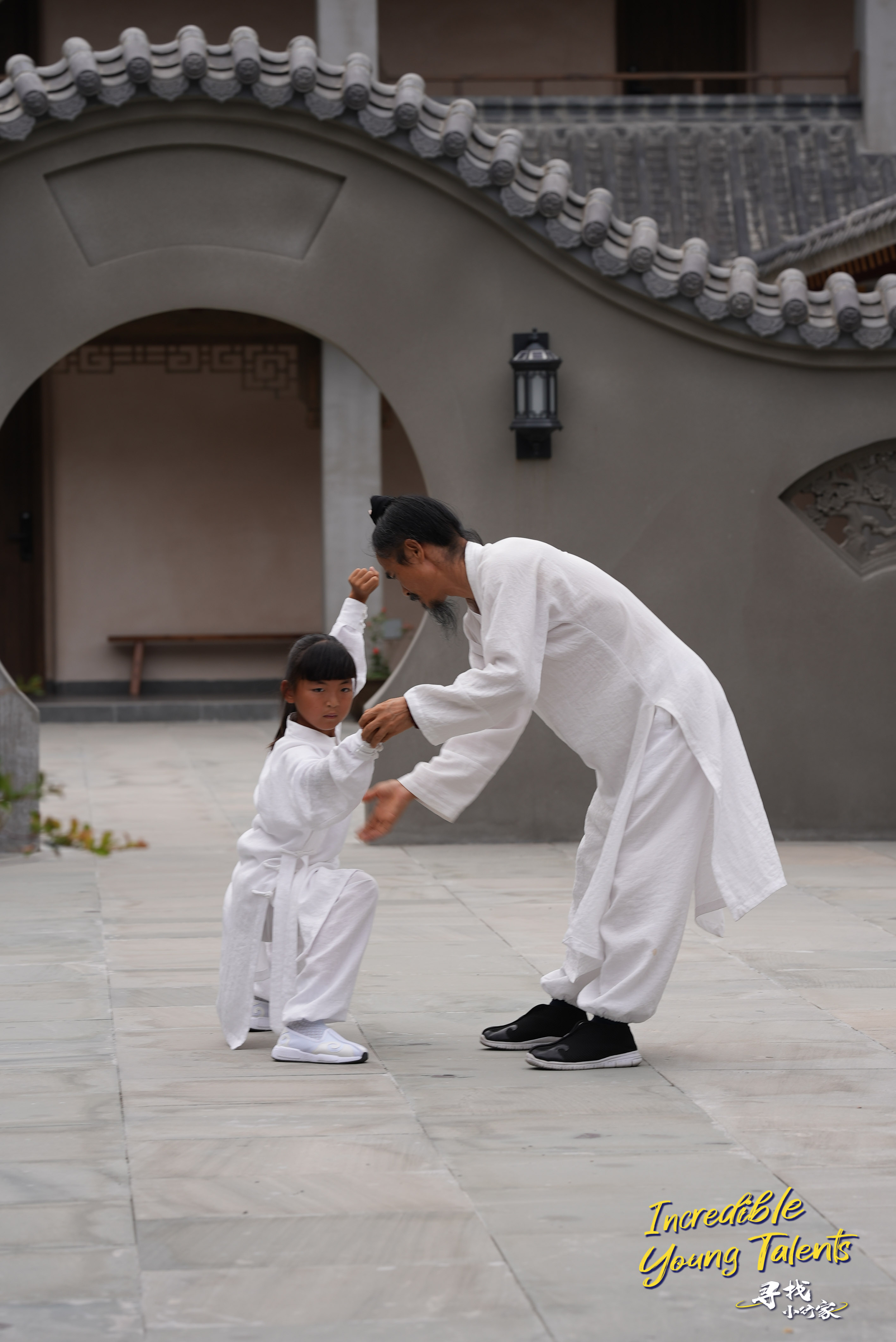 Young kung fu practitioner Li Muzi learns Tai Chi routines from her master. /CGTN