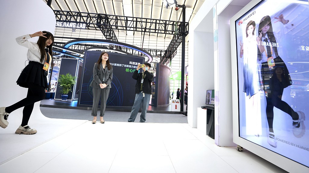 A visitor interacts with the digital figure at the Light of Internet Expo of the WIC. /CFP