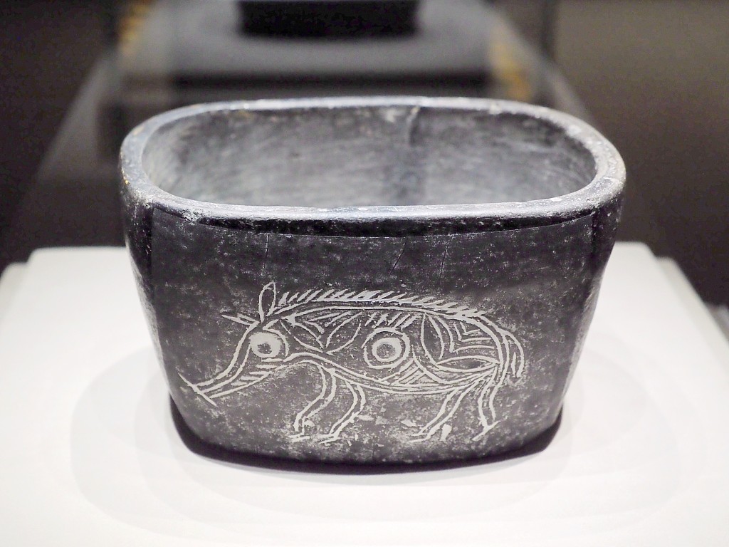 A photo taken on November 8, 2023, shows a bowl engraved with a pig, on display at a Hemudu Culture exhibition at the National Museum of China in Beijing. /CFP