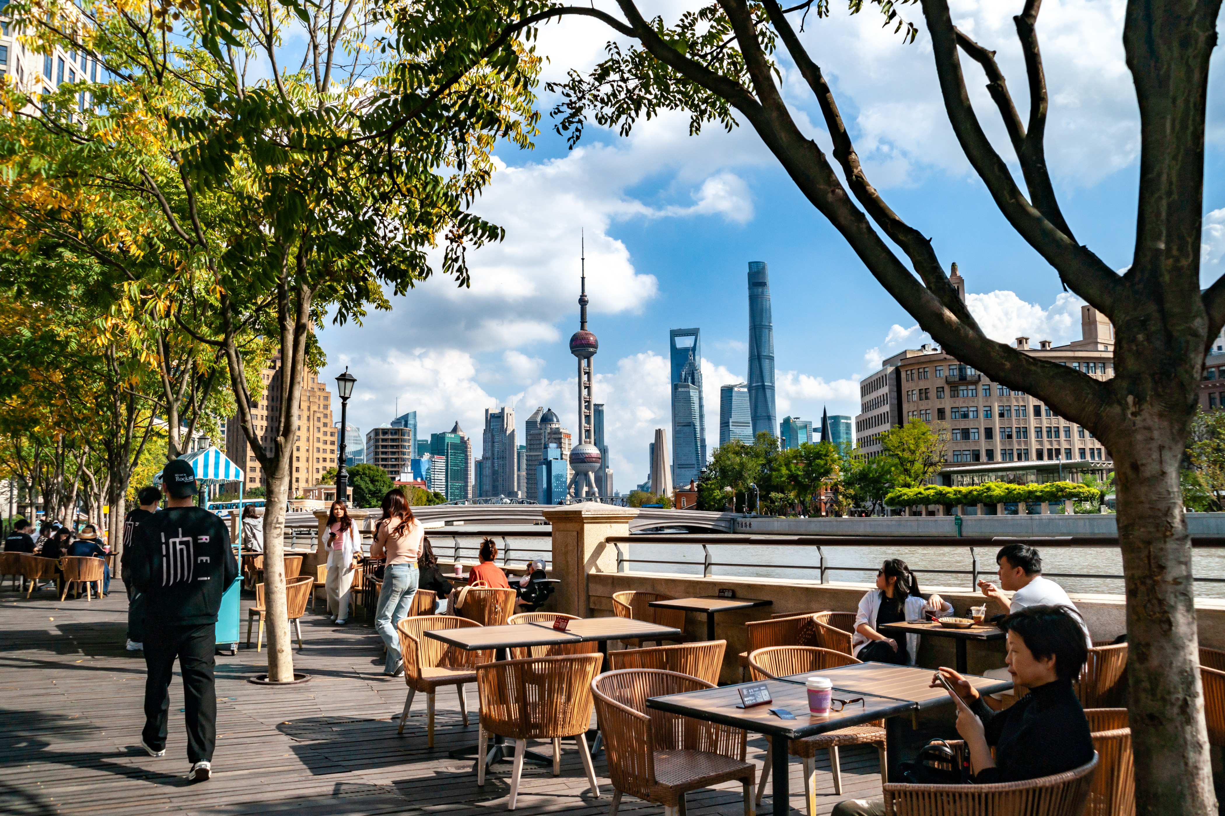 People enjoy their free time at a cafe along the Bund in Shanghai, October 30, 2023. /IC
