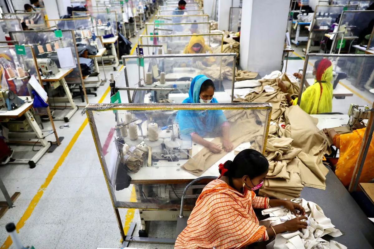 Employees work on clothes at The Civil Engineering Limited garment factory in Dhaka, Bangladesh, August 17, 2021. /Reuters