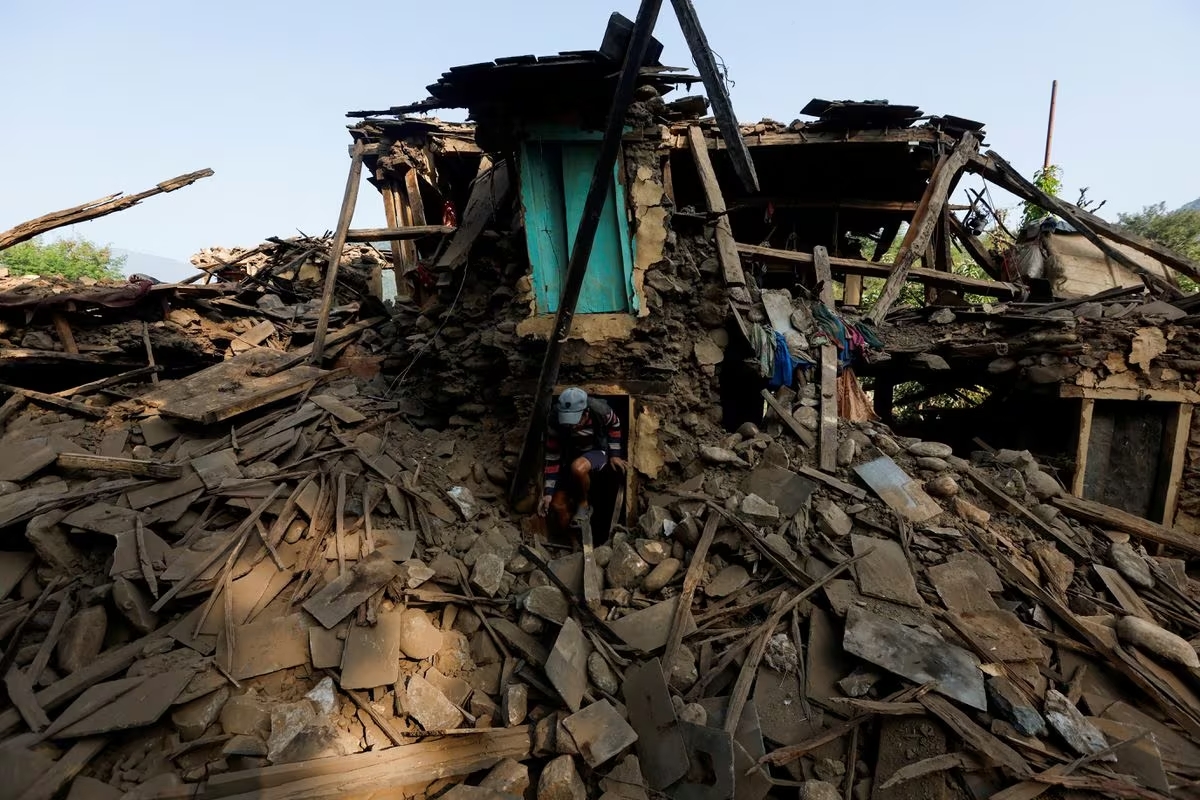 A man salvages goods from his collapsed house after an earthquake in Jajarkot, Nepal. November 6, 2023. /Reuters