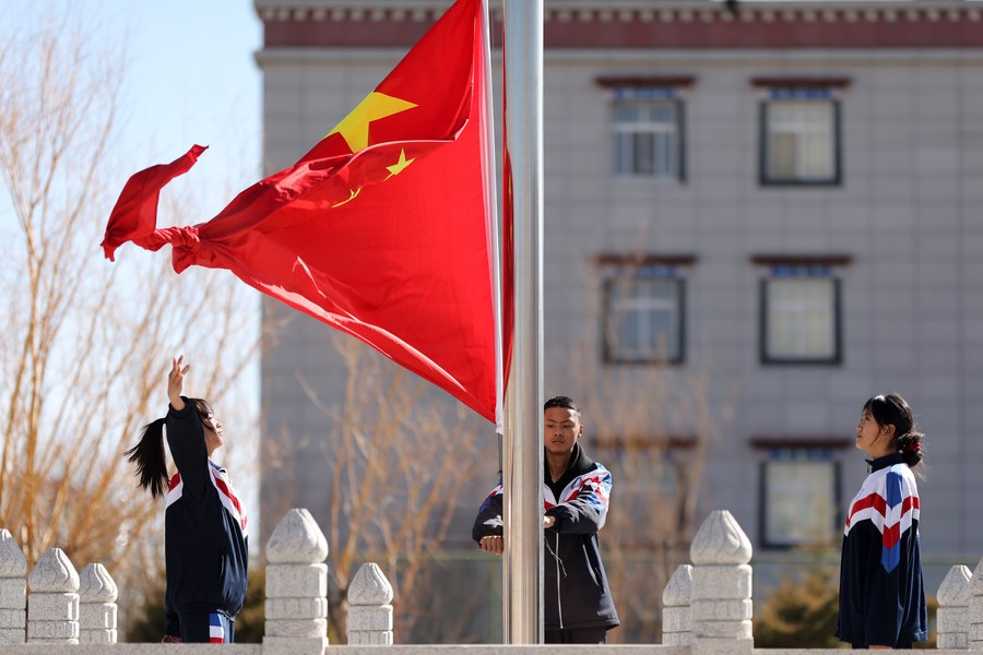 Students at the Lhasa Jiangsu Experimental High School hold a flag-raising ceremony in Lhasa, capital of southwest China's Xizang Autonomous Region, March 10, 2022. /Xinhua