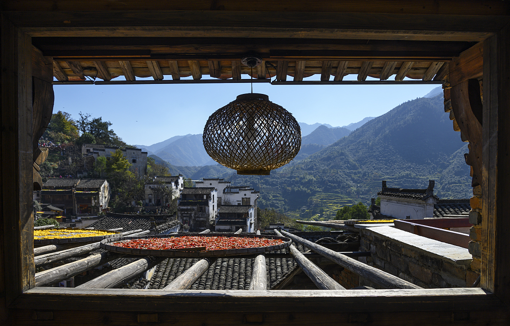 Crops are put in big bamboo baskets and then placed on crossbeams sticking out from the rooftop in Huangling village, Wuyuan County, east China's Jiangxi Province. /CFP