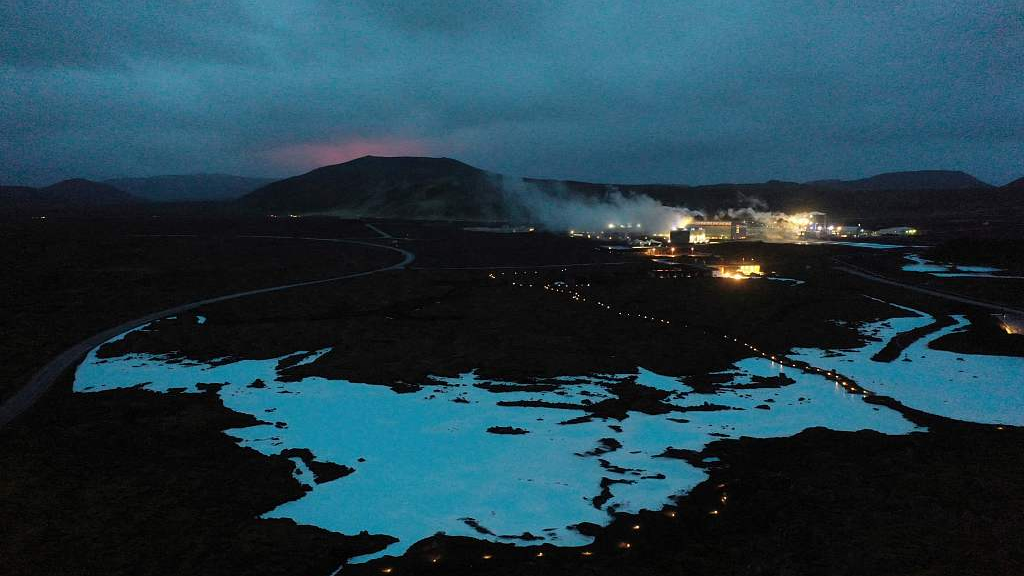 File: The red shimmer of magma is seen coming out from the erupting Fagradalsfjall volcano behind the tourist landmark Blue Lagoon, near the town of Grindavik some 40 kilometers west of the Icelandic capital Reykjavik, on March 20, 2021. /CFP