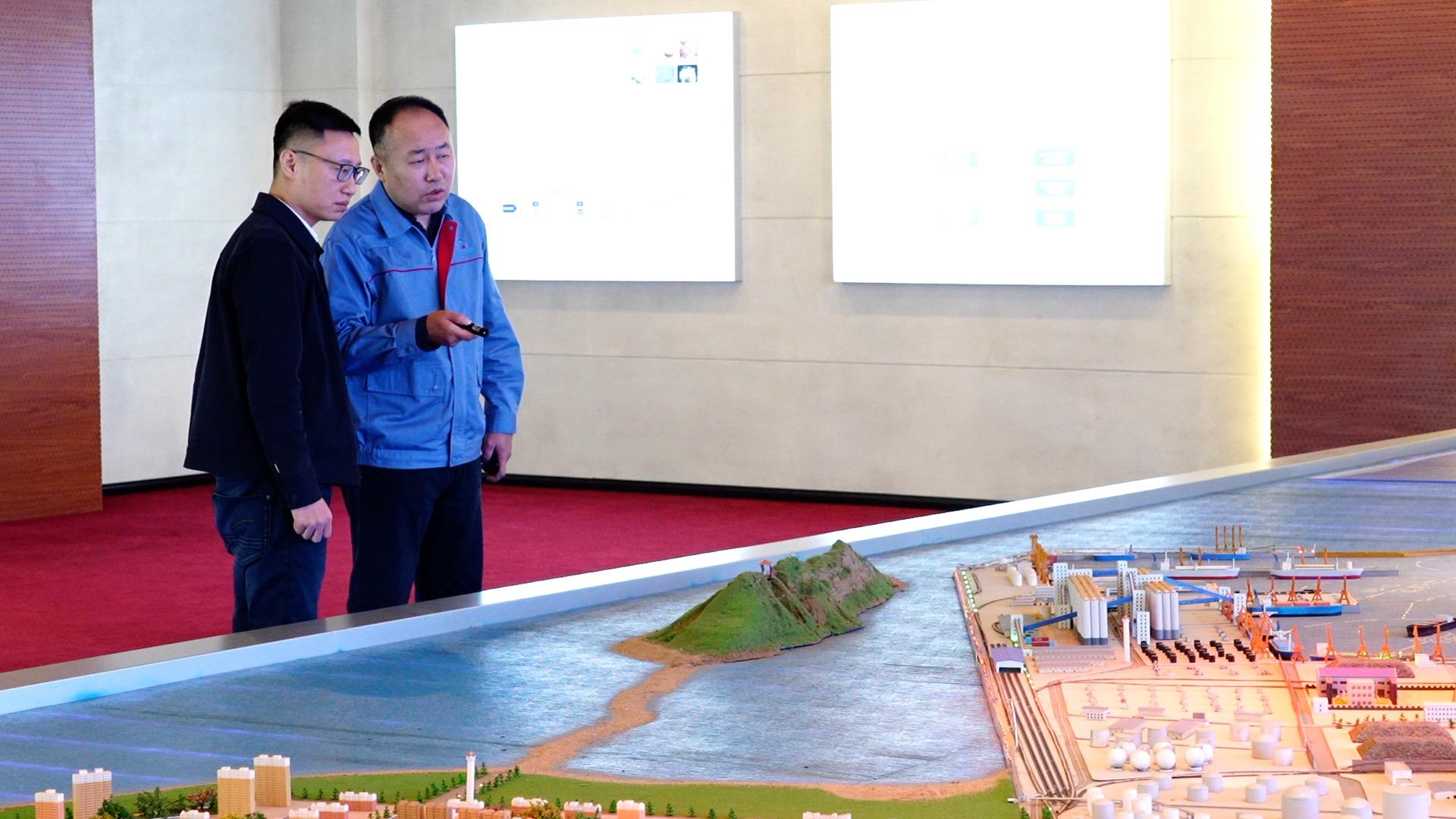 Wang Jian (right), the deputy marketing dirctor of Jinzhou port, told CGTN: 
