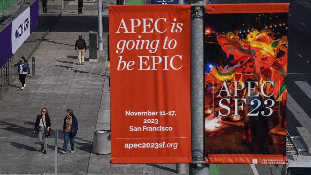People walk under signage advertising the Asia-Pacific Economic Cooperation Leaders' Meeting 2023 at the Moscone Center in San Francisco, California, U.S., November 9, 2023. /CFP