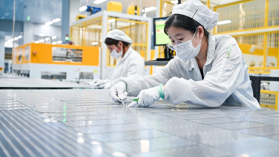 Staff members work at a workshop of a photovoltaic technology company in Yancheng, east China's Jiangsu Province, September 6, 2023. /Xinhua