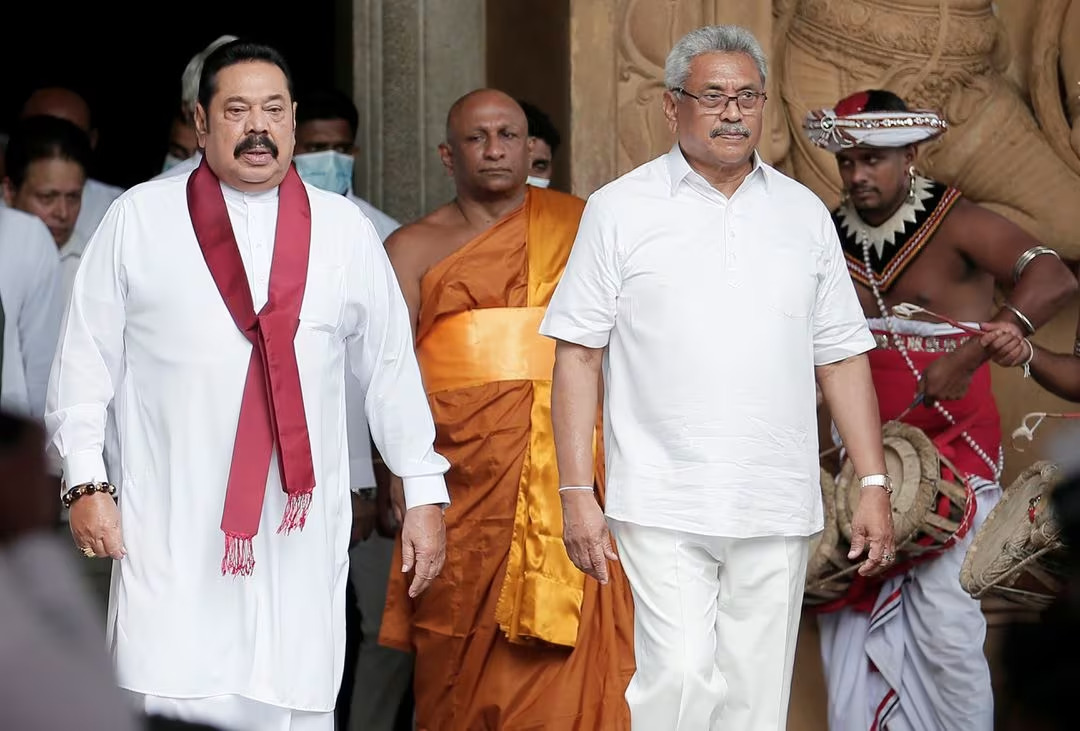 Sri Lanka's former Prime Minister Mahinda Rajapaksa (L) and his brother, the Sri Lanka's former President Gotabaya Rajapaksa, are seen during his during the swearing in ceremony as the new Prime Minister, at Kelaniya Buddhist temple in Colombo, Sri Lanka, August 9, 2020. /Reuters