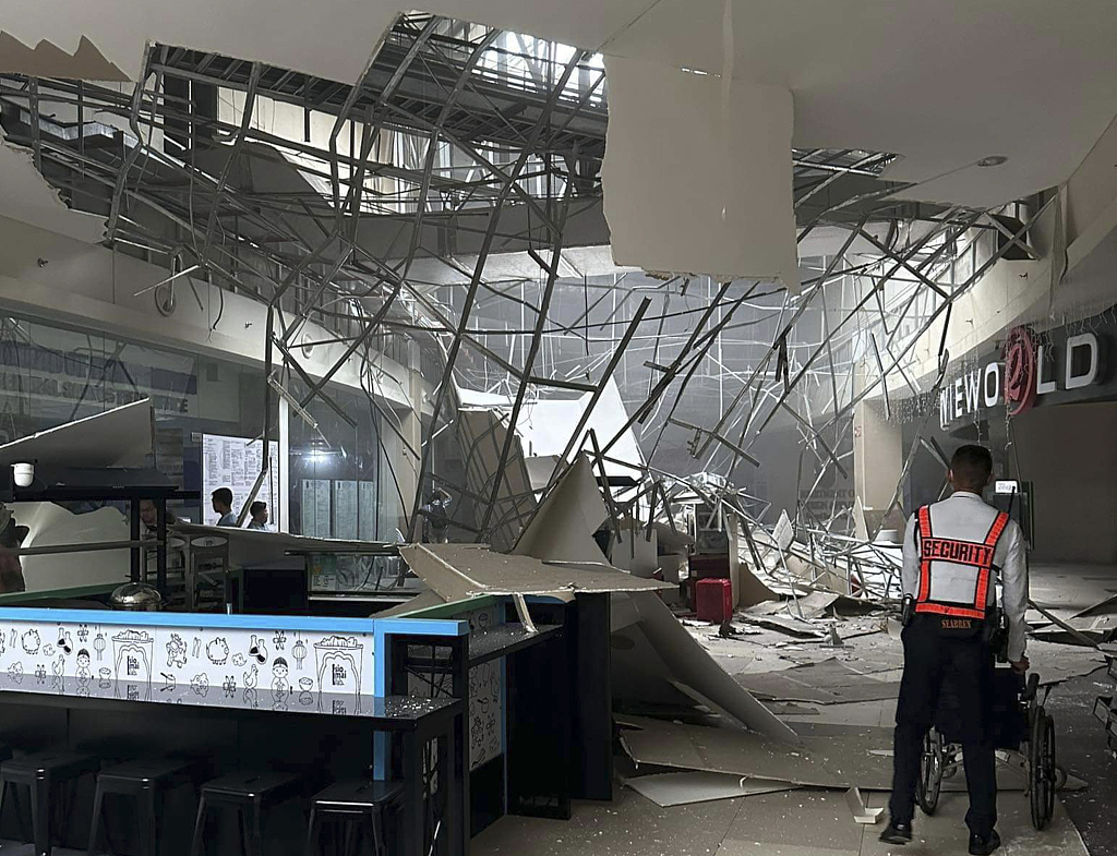 A security guard walks beside the damaged ceiling of a shopping mall in General Santos City, South Cotabato, southern Philippines, November 17, 2023. /CFP