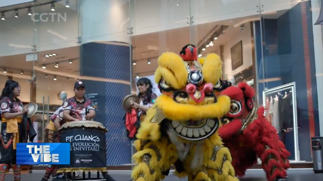 A lion dance performance attracts attention from the passersby on the street in Mexico City. /CGTN