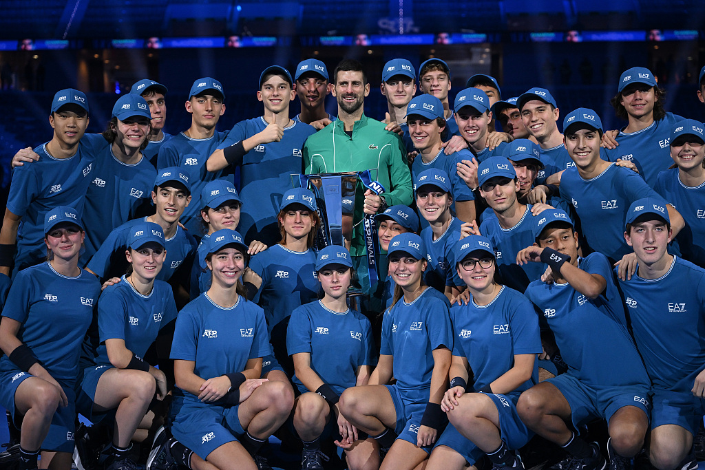 Novak Djokovic poses for a photo with the ball kids after winning the singles final tennis match of the ATP Finals in Turin, Italy, November 19, 2023. /CFP