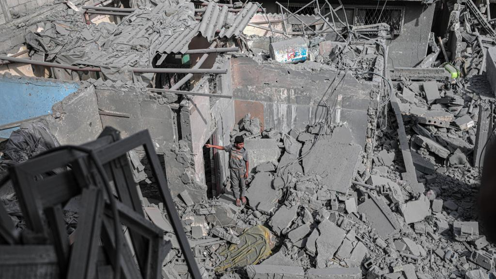 A boy stands among the rubble of buildings destroyed in an Israeli bombing at Bureij refugee camp in central Gaza Strip, November 13, 2023. /Xinhua