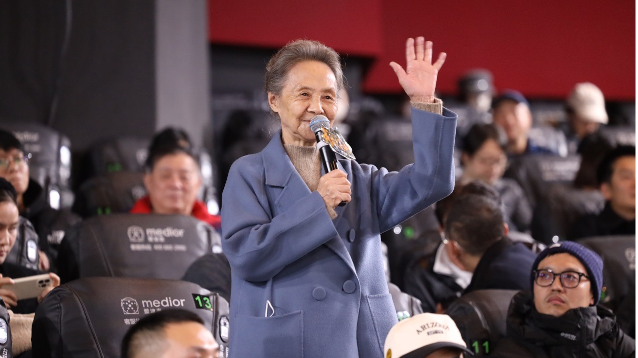 Acclaimed veteran actress Wu Yanshu speaks at a prescreening event for the upcoming film “Beyond the Clouds” in Beijing on November 16, 2023. /Photo provided to CGTN