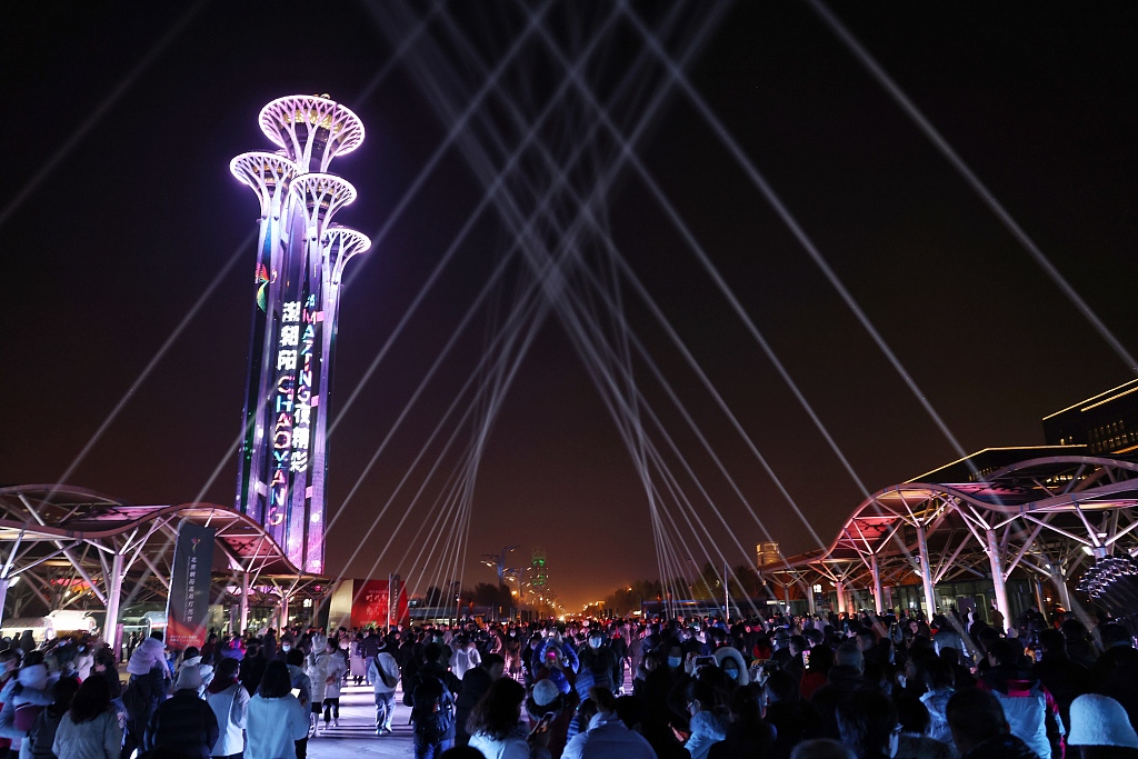 People enjoy a light show at Beijing Olympic Park as the 2023 Beijing Chaoyang International Light Festival kicks off on November 18. /CFP
