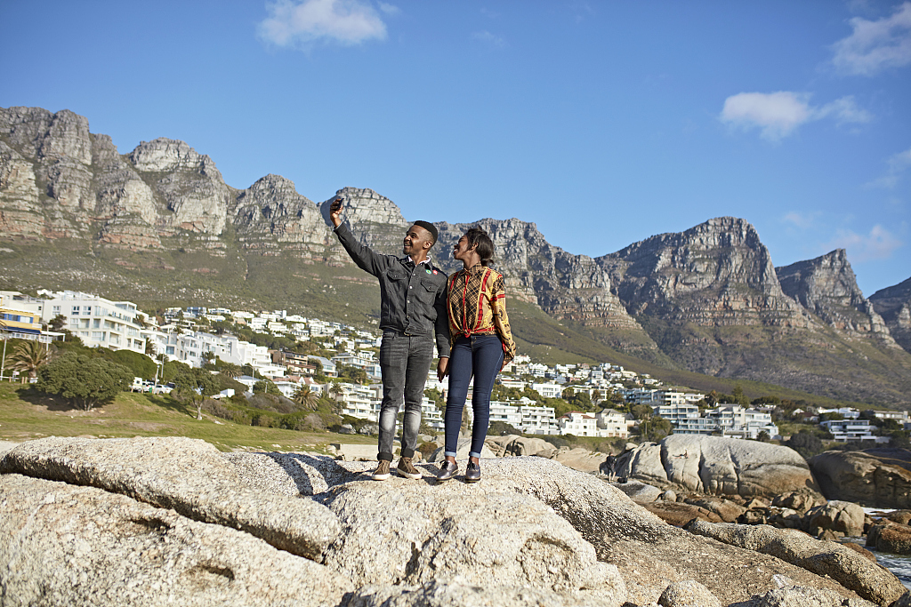 A file photo shows people taking a selfie with the Twelve Apostles Mountain Range in Cape Town, South Africa as a backdrop. /CFP