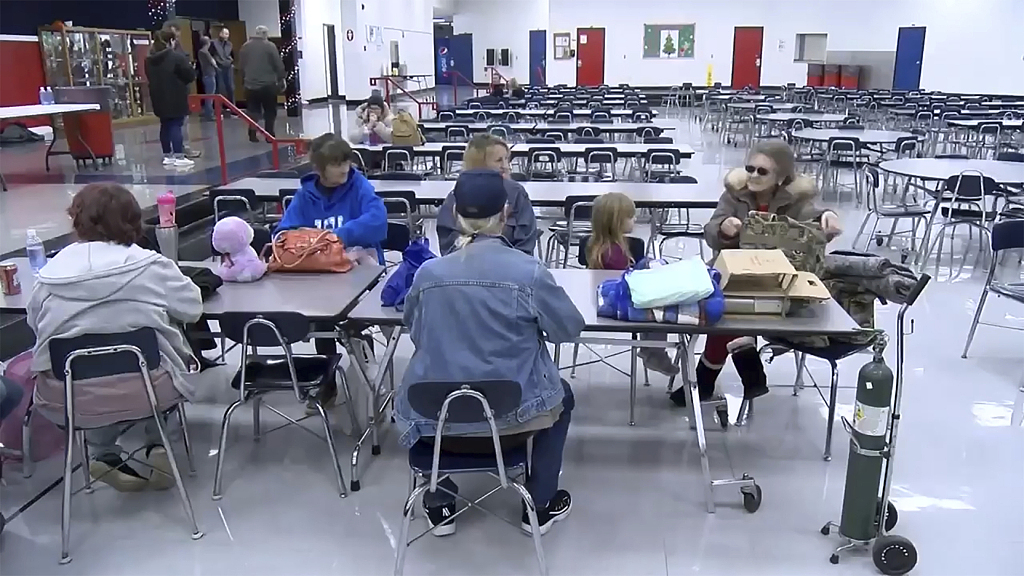 A screenshot shows people sitting at a table at Rockcastle Middle School being used as an evacuation center in Mt Vernon, Kentucky, U.S., November 22, 2023. /CFP