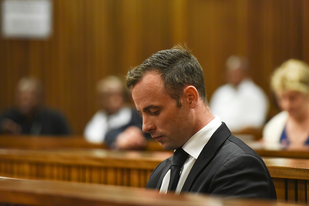 Former Paralympic star Oscar Pistorius sits in the South African Gauteng Division High Court in Pretoria, South Africa, ahead of his hearing on December 8, 2015. /CFP
