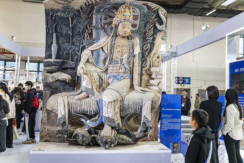 People appreciate a Buddhist sculpture during China Craft Week in Hangzhou City, Zhejiang Province, November 25, 2023. /CFP