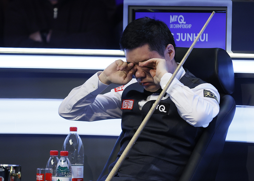 Ding Junhui rubs his eyes during his match against Mark Allen on day one of the Snooker UK Championship at York Barbican, in York, England, November 25, 2023. /CFP