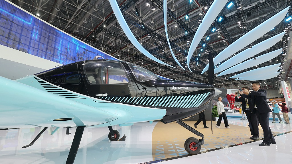 Visitors take photo of an aircraft of AG100 on display at the 2023 Aero Asia show in Zhuhai City, South China's Guangdong Province, November 23, 2023. /CFP
