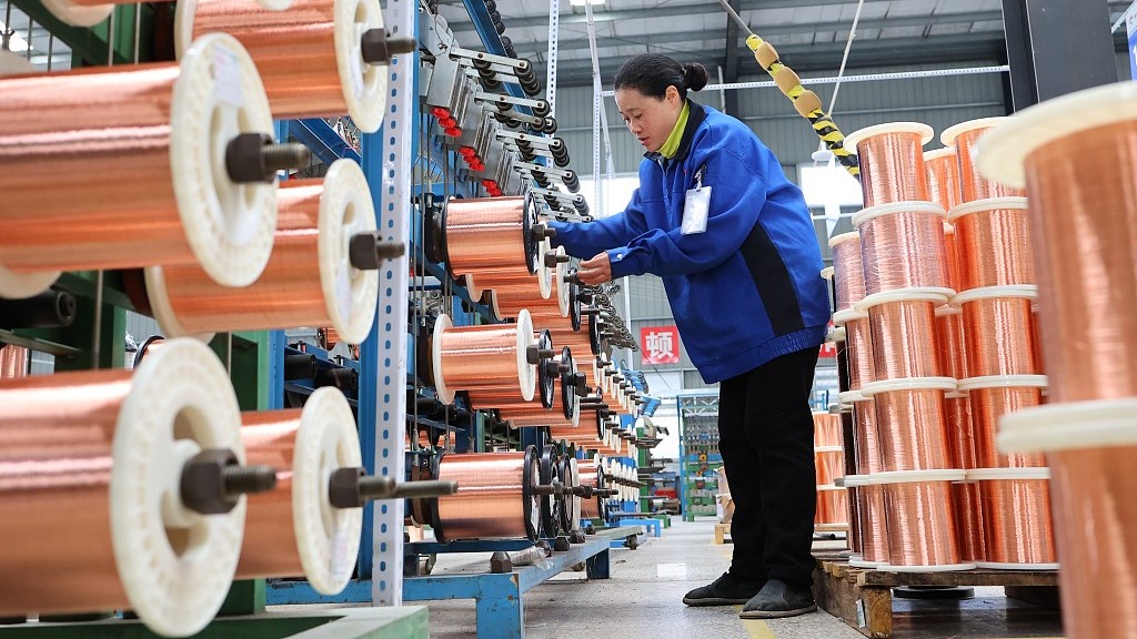 A worker operates at a production plant in southwest China's Chongqing municipality, November 18, 2023. /CFP