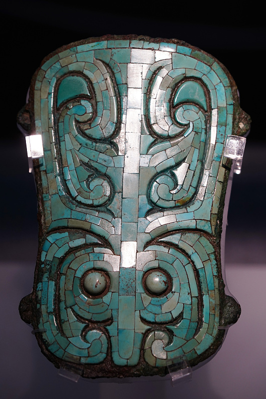 The photo, taken on November 24, 2023, shows a turquoise-inlaid bronze plaque from the Erlitou site exhibited at the Chinese Archaeological Museum in Beijing. /CFP