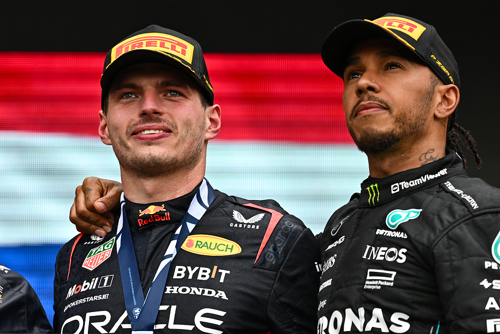 Race winner Max Verstappen (L) of Red Bull Racing and third placed Lewis Hamilton of Mercedes celebrate on the podium after the F1 Grand Prix of Canada at Circuit Gilles Villeneuve in Montreal, Quebec, June 18, 2023. /CFP